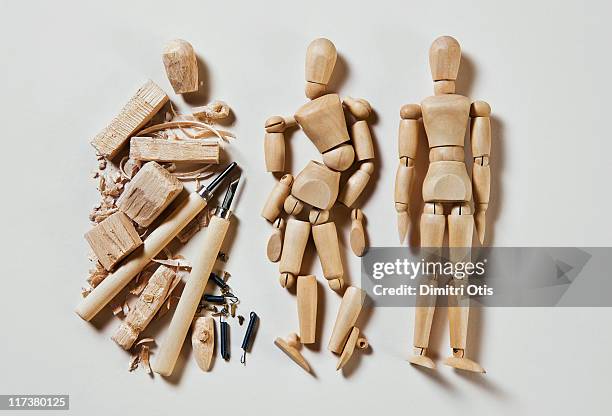 three wood mannequins in stages of production - indecisive stockfoto's en -beelden