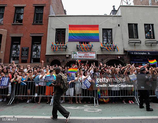 People stand outside of The Stonewall Inn during the 2011 NYC LGBT Pride March on the streets of Manhattan on June 26, 2011 in New York...