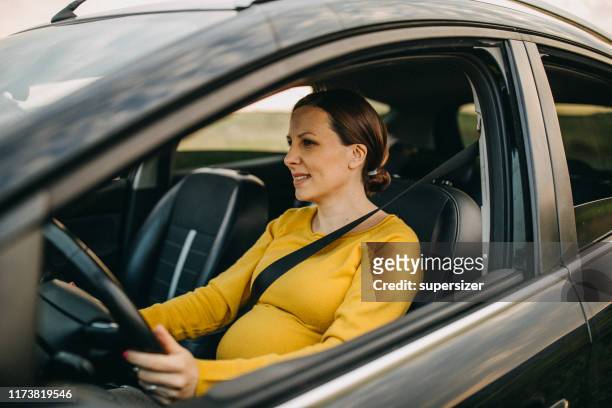 pregnant woman driving the car - pregnant woman car stock pictures, royalty-free photos & images