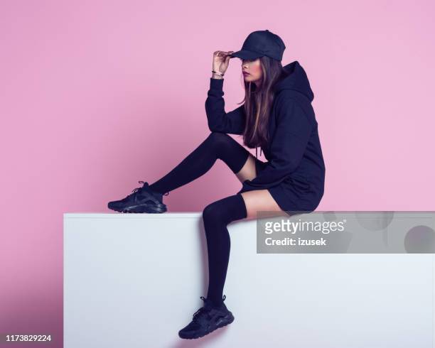 fashion portrait of rebel young woman - knee length stock pictures, royalty-free photos & images