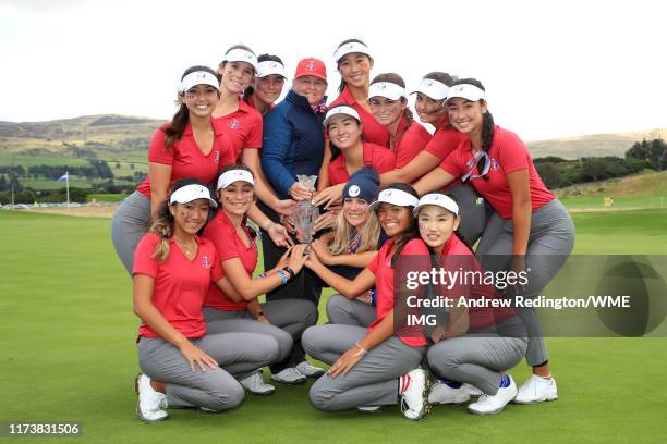 Team USA pose for a photograph with the Trophy after they win the PING Junior Solheim Cup during Preview Day 3 of The Solheim Cup at Gleneagles on...