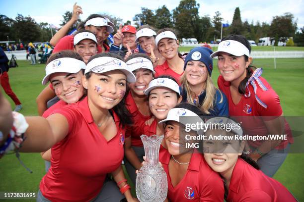 Team USA pose for a selfie photograph with the Trophy after they win the PING Junior Solheim Cup during Preview Day 3 of The Solheim Cup at...