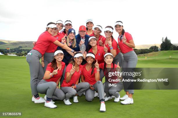 Team USA pose for a photograph with the Trophy after they win the PING Junior Solheim Cup during Preview Day 3 of The Solheim Cup at Gleneagles on...