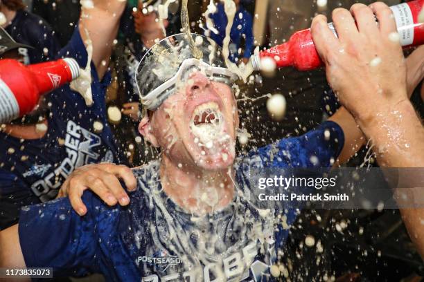 Hitting coach and hitting strategist Brant Brown of the Los Angeles Dodgers celebrates with his team in the clubhouse after defeating the Baltimore...