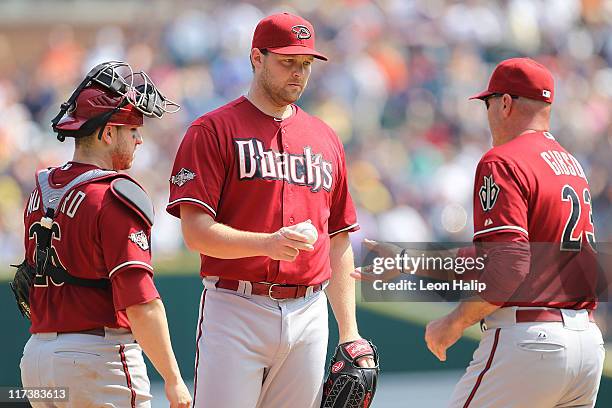 Aaron Heilman of the Arizona Diamondbacks hands the ball to manager Kirk Gibson in the eighth inning of the game against the Arizona Diamondbacks at...