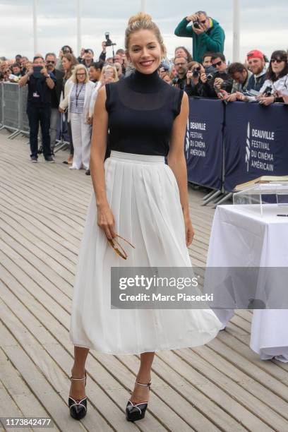 Actress Sienna Miller poses next to the beach closet dedicated to her during the 45th Deauville American Film Festival on September 11, 2019 in...