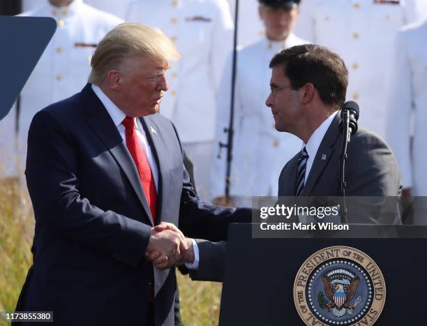 President Donald Trump shakes hands with Secretary of Defense Mark Esper during a 911 memorial ceremony at the Pentagon to commemorate the...