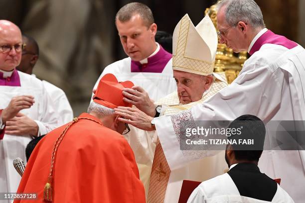 Pope Francis puts the biretta as he appoints Cardinal Guatemalan prelate Alvaro Leonel Ramazzini Imeri during an Ordinary Public Consistory for the...