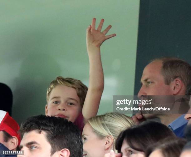 Prince George waving at Carrow Road as he watches with his father Prince William during the Premier League match between Norwich City and Aston Villa...