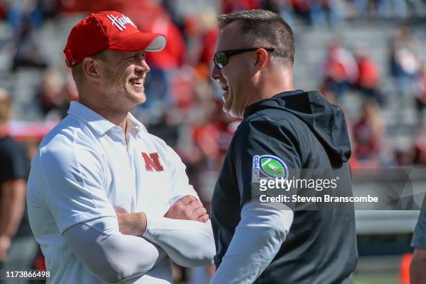 Head coach Scott Frost of the Nebraska Cornhuskers and head coach Pat Fitzgerald of the Northwestern Wildcats meet on the field before the game at...