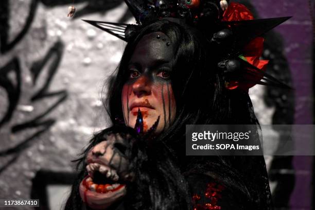 Participant seen dressed as zombie during the annual charity walk. People wearing zombie costumes gather in London to join efforts in an annual...