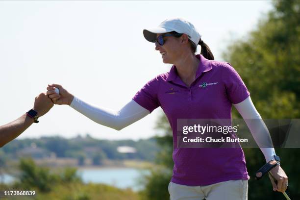 Katherine Perry gets a fist bump after making an eagle putt on the sixth hole during the Third Round of the Volunteers of America Classic golf...