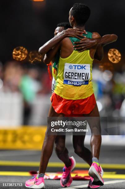 Doha , Qatar - 5 October 2019; Lelisa Desisa of Ethiopia, hidden, is helped to his feet by team-mate Mosinet Geremew after winning the Men's Marathon...