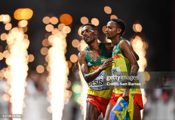 Doha , Qatar - 5 October 2019; Lelisa Desisa of Ethiopia, left, is helped to his feet by team-mate Mosinet Geremew after winning the Men's Marathon...