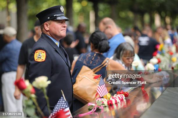 Friends and family of victims of the September 11 terrorist attacks, pause at the National September 11 Memorial during a morning commemoration...