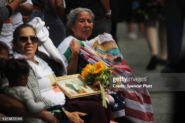 Friends and family of victims of the September 11 terrorist attacks, pause at the National September 11 Memorial during a morning commemoration...