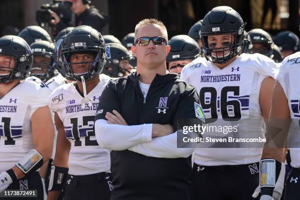 Head coach Pat Fitzgerald of the Northwestern Wildcats waits with the team to enter the field before the game against the Nebraska Cornhuskers at...