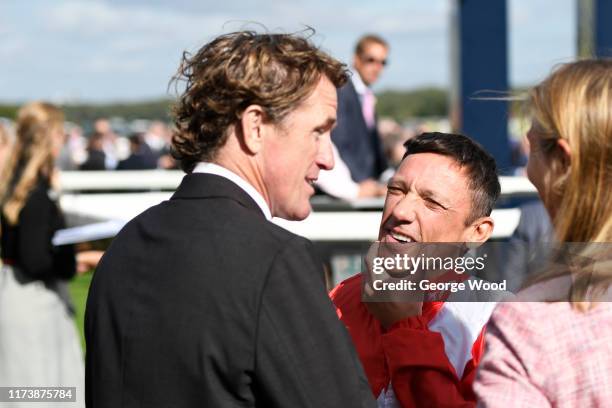 Jockey Frankie Dettori talks with former Jockey Sir AP McCoy during the St Ledger Festival at Doncaster Racecourse on September 11, 2019 in...