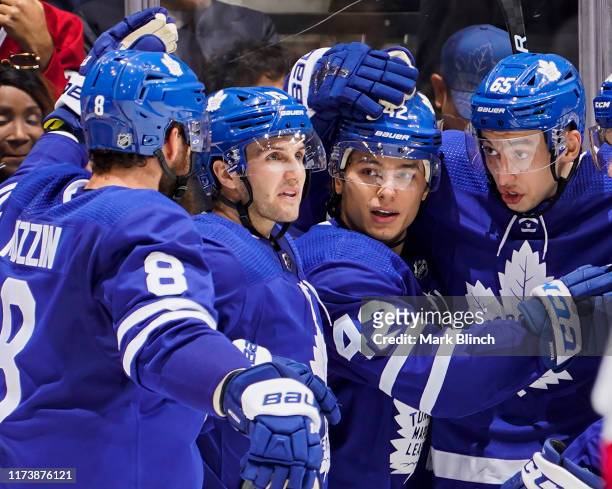 Trevor Moore of the Toronto Maple Leafs celebrates his goal against the Montreal Canadiens with teammates Jake Muzzin, Alexander Kerfoot and Ilya...