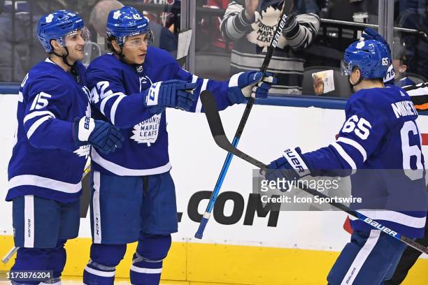 Toronto Maple Leafs Right Wing Trevor Moore celebrates a second period goal with Center Alexander Kerfoot and Left Wing Ilya Mikheyev during the...