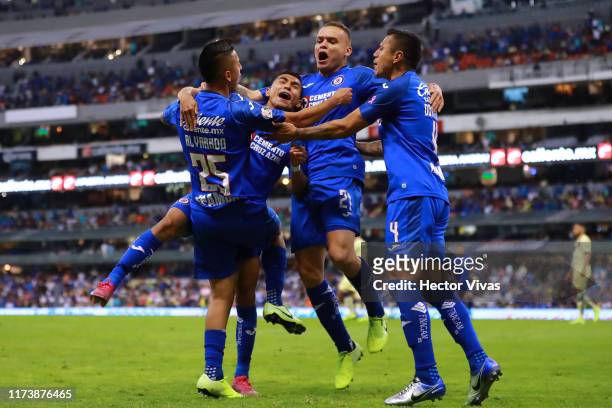 Roberto Alvarado of Cruz Azul celebrates with teammates after scoring the third goal of his team during the 13th round match between Cruz Azul and...