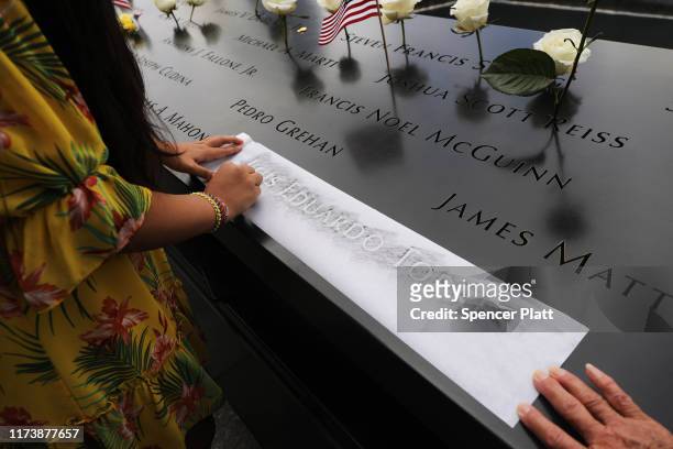 The niece of Luis Eduardo Torres, who was killed while working as a broker at Cantor Fitzgerald, copies out his name at the National September 11...