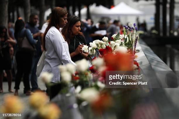 Friends and family of victims of the September 11 terrorist attacks, pause at the National September 11 Memorial during a morning commemoration...