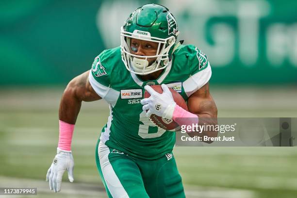 Marcus Thigpen of the Saskatchewan Roughriders runs with the ball in the game between the Winnipeg Blue Bombers and Saskatchewan Roughriders at...