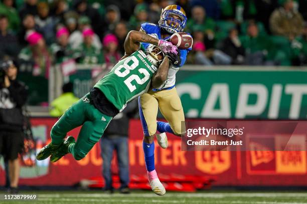 Marcus Sayles of the Winnipeg Blue Bombers is called for pass interference on a pass intended for Naaman Roosevelt of the Saskatchewan Roughriders in...