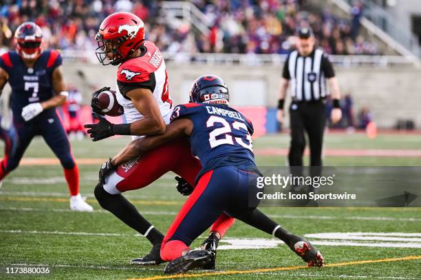 Montreal Alouettes defensive back Tommie Campbell tackles Calgary Stampeders wide receiver Eric Rogers during the Calgary Stampeders versus the...