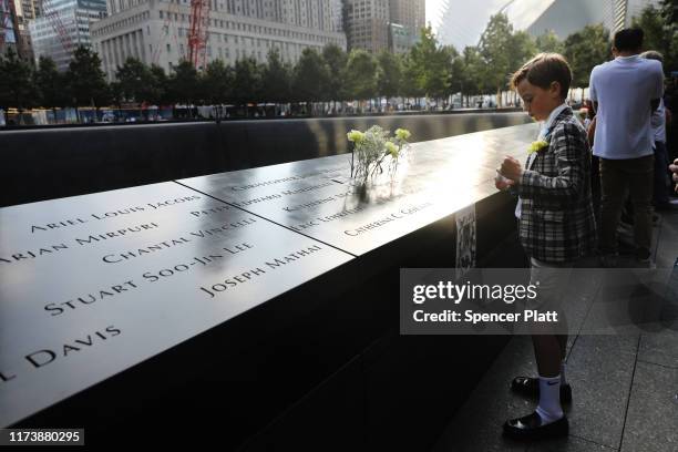 John Timson pauses at the National September 11 Memorial where his uncle Andrew Fisher's name is etched into a panel with other victims during a...