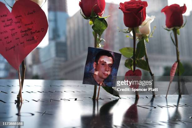 Picture is placed in a name along the National September 11 Memorial during a morning commemoration ceremony for the victims of the terrorist attacks...
