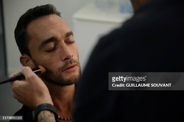 French artist Jean-Baptiste Guegan, a vocal look-alike of late French artist Johnny Hallyday is preparing in his dressing room before his concert at...