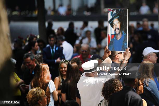 Friends and family of victims of the September 11 terrorist attacks, pause at the National September 11 Memorial during a morning commemoration...