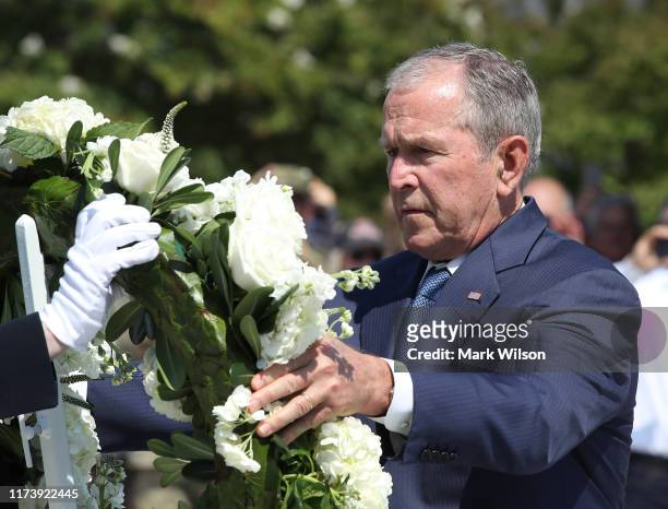 Former U.S. President George W. Bush participates in a wreath-laying ceremony at the 9/11 Pentagon Memorial to commemorate the anniversary of the...