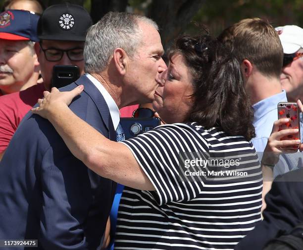 Former U.S. President George W. Bush greets Lisa Dolan, whose husband US Navy Capt. Robert Dolan was killed at the Pentagon, during a wreath-laying...