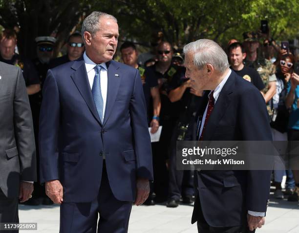 Former U.S. President George W. Bush and former U.S. Secretary of Defense Donald Rumsfeld participate in a wreath-laying ceremony at the 9/11...