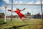Soccer penalty kick with teen female goalkeeper