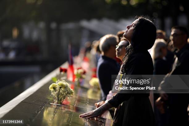 Alexandra Hamatie, whose cousin Robert Horohoe was killed on September 11, pauses at the National September 11 Memorial during a morning...