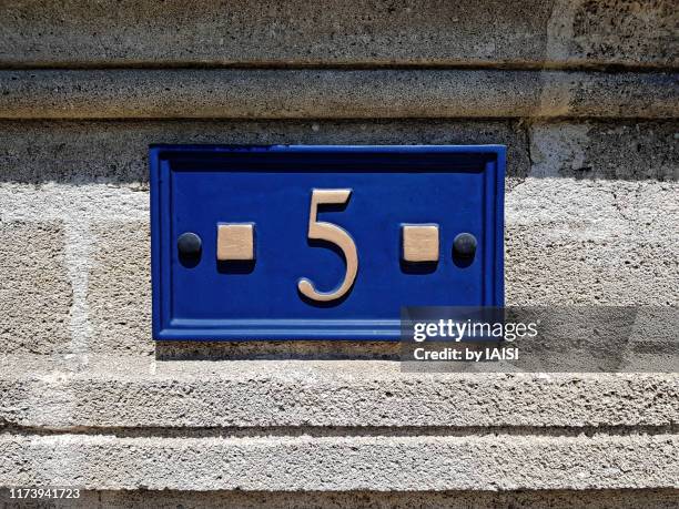 geometric composition of house number address on stone wall - house number stock pictures, royalty-free photos & images