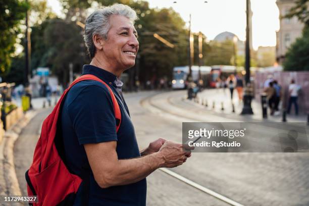 senior man standing on the street - baby mobile stock pictures, royalty-free photos & images