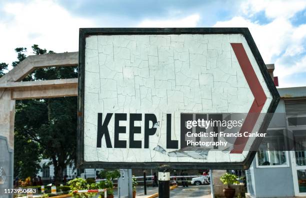 "keep left" sign pointing to the right - keep out sign imagens e fotografias de stock