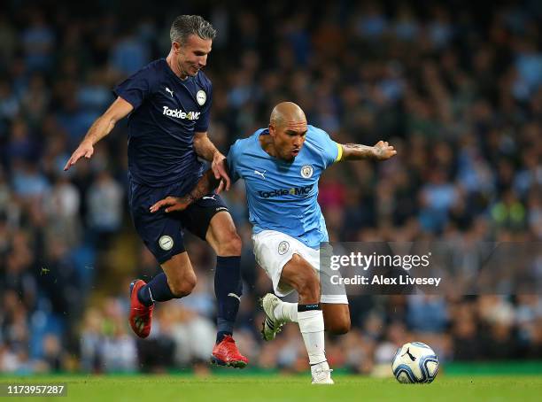 Nigel de Jong of Manchester City legends is tackled by Robin Van Persie of Premier League All-Starts XI during the Vincent Kompany testimonial match...