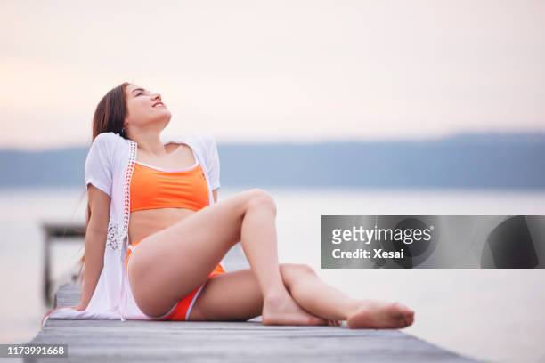 Young woman have fun on the beach and feel the freedom alone