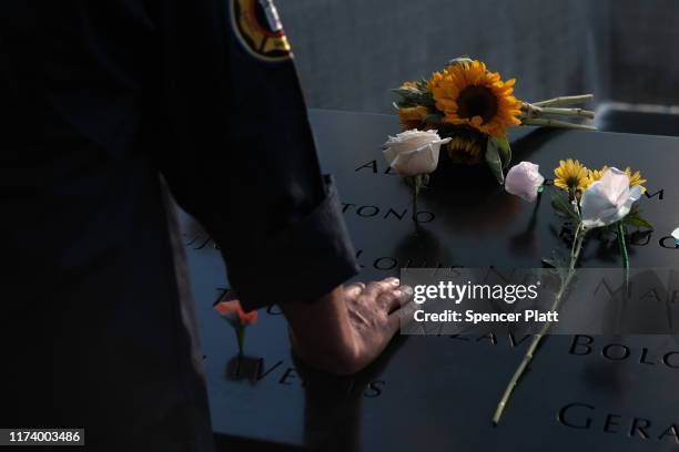 People gather at one of the pools at the National September 11 Memorial following a morning commemoration ceremony for the victims of the terrorist...