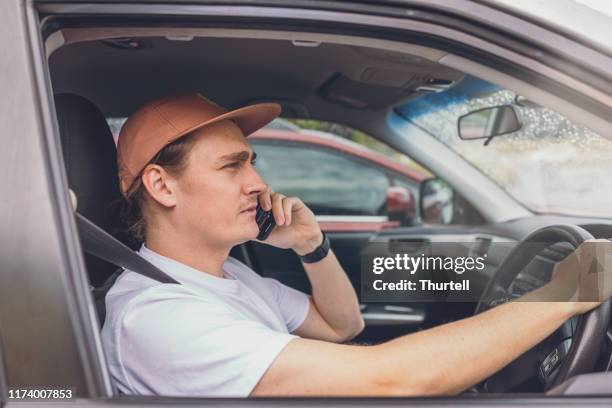 driver talking on mobile phone while driving - distracted stock pictures, royalty-free photos & images
