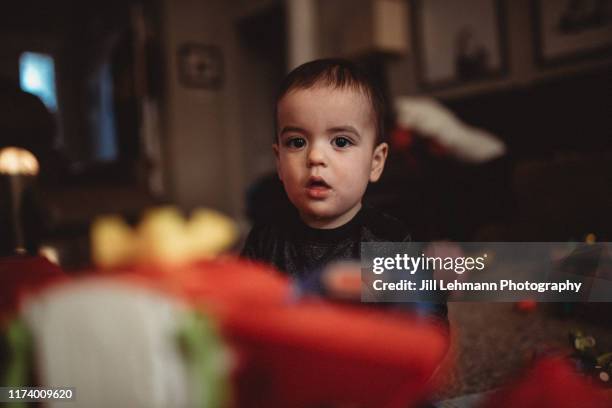 portrait of a male 2 year old toddler playing with toys in middle class home - mouth smirk stock pictures, royalty-free photos & images