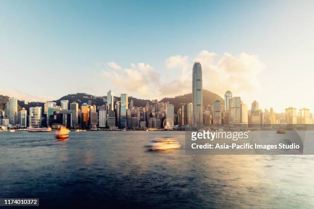 hong kong skyline at sunset. - victoria hong kong stock pictures, royalty-free photos & images