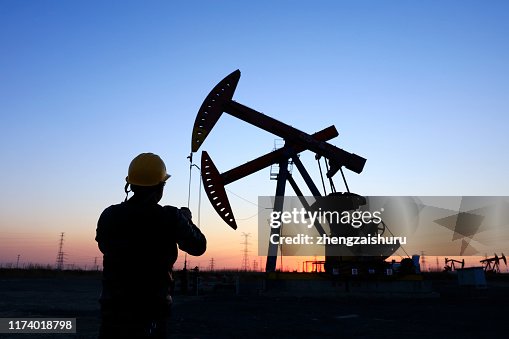 Oil field, the oil workers are working Oil field, the oil workers are working