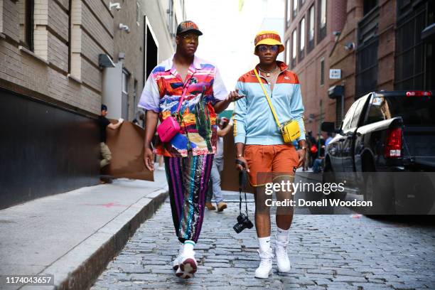 Two guests are seen walking with Marc Jacobs accessories during New York Fashion Week on September 11, 2019 in New York City.